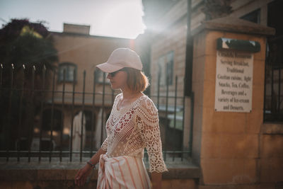 Side view of woman looking at city