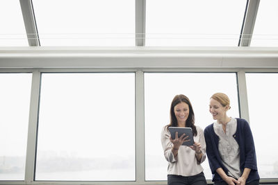 Businesswomen using digital tablet in office