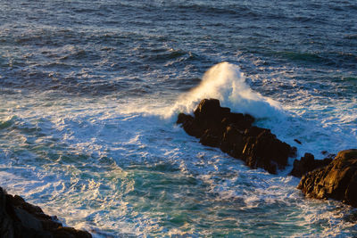 Waves splashing on rocks at shore