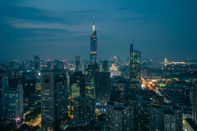 Illuminated cityscape against sky at night