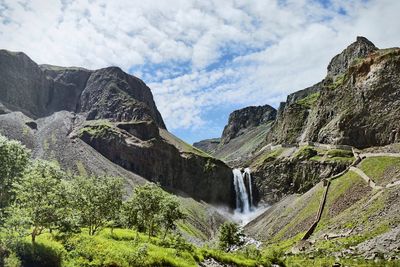 Low angle view of waterfall against sky