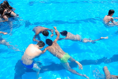 High angle view of people swimming in pool