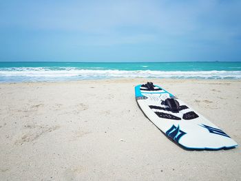 Scenic view of surfboard on beach