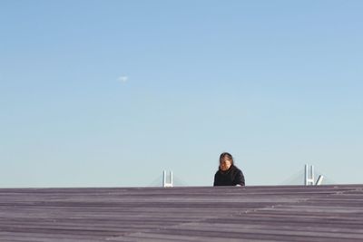 Woman standing against clear sky