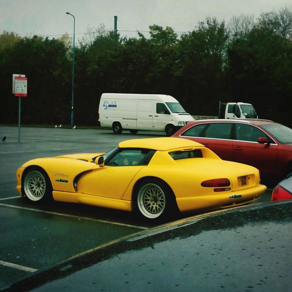 YELLOW VINTAGE CAR ON STREET