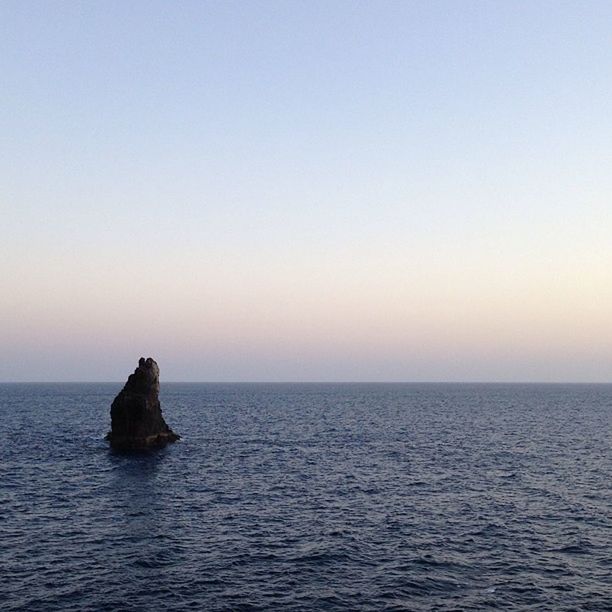 sea, horizon over water, water, tranquil scene, scenics, tranquility, copy space, clear sky, waterfront, beauty in nature, nature, idyllic, rippled, sunset, seascape, rock - object, sky, remote, rock formation, calm