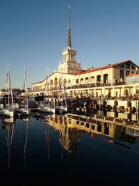 Sea. port. the sun. evening sky. reflection of buildings in water