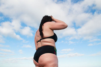 Low angle view of woman against sky