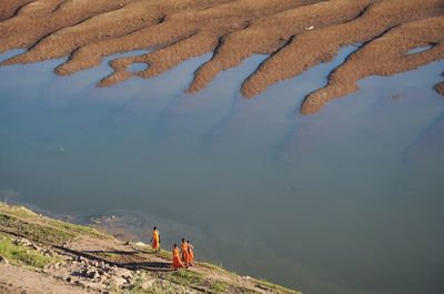 Monks walking on shore