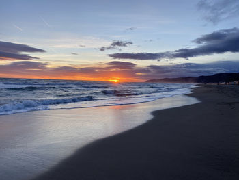 Scenic view of beach against sky during sunset