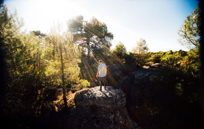 Man in forest against sky