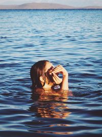 Young woman swimming in sea