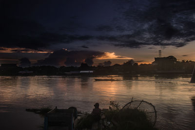 Scenic view of silhouette buildings against sky during sunset