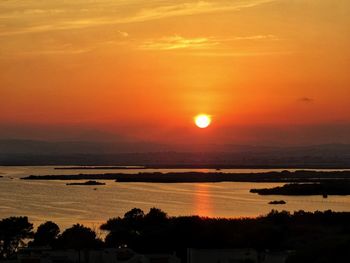 Scenic view of sea against romantic sky at sunset
