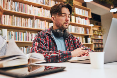 Portrait of young man working at table