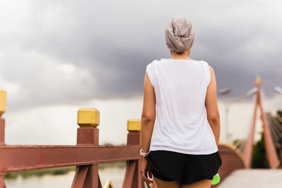 Woman exercise walking on the bridge in the park.