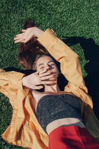 High angle view of portrait of woman sleeping on grass