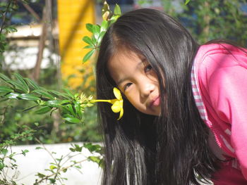 Close-up of smiling girl with flowers