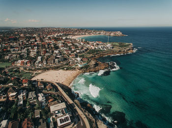 High angle view of townscape by sea against sky