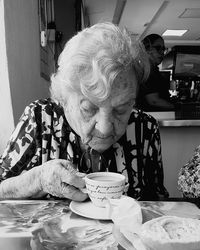 Portrait of woman sitting on table