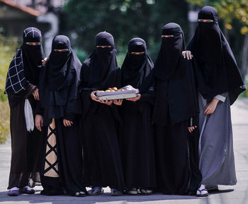 Full length of teenage girls wearing burkas
