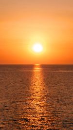 Scenic view of sea against romantic sky at sunset