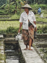 Full length of man standing in farm