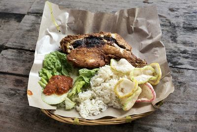 High angle view of ayam penyet served in basket