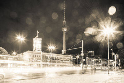 Illuminated city against sky at night