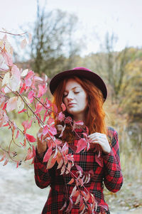 Portrait of beautiful young woman standing outdoors