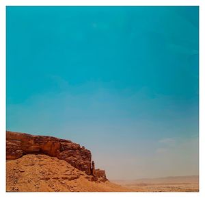 Rock formation on land against blue sky