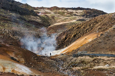 Scenic view of landscape with smoke