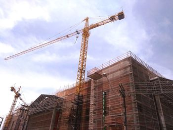 Low angle view of construction site against sky