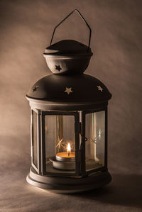 Close-up of illuminated lamp on table