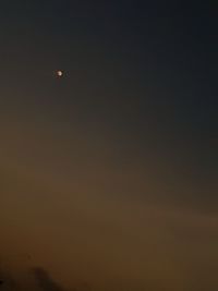 Low angle view of moon in sky at night