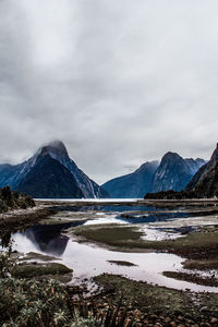 Scenic view of lake and mountains against sky