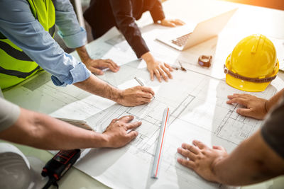 High angle view of people working on table