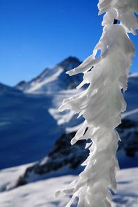 Close-up of frozen mountain against sky