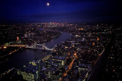 High angle view of illuminated cityscape against sky at night