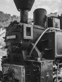 Close-up of train on railroad track against sky