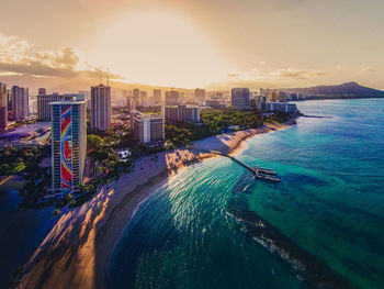 High angle view of buildings by sea against sky