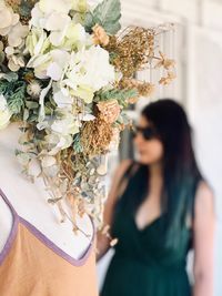 Woman standing by potted plant