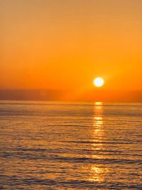 Scenic view of sea against romantic sky at sunset