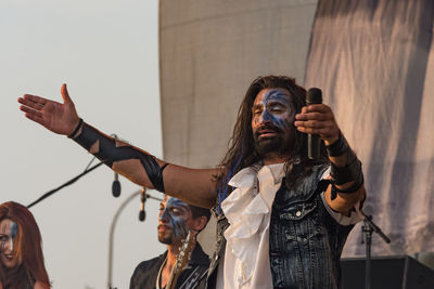 Full length of man with arms raised