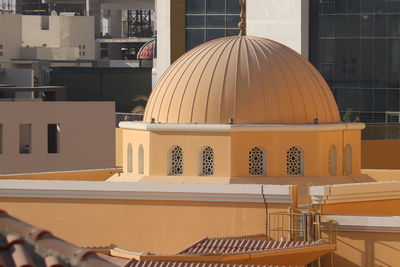 Chairs and tables against buildings in city