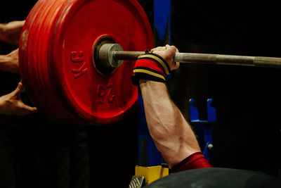 Midsection of man exercising in gym