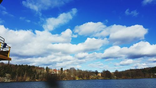 Scenic view of lake and forest against cloudy sky