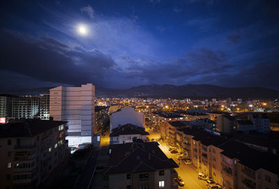 High angle view of illuminated buildings in city at night