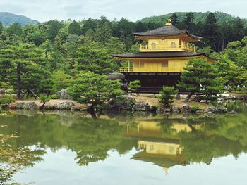 Reflection of trees and building on lake