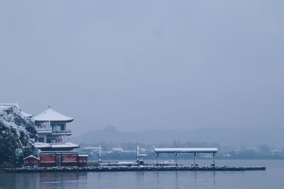 Building by sea against sky